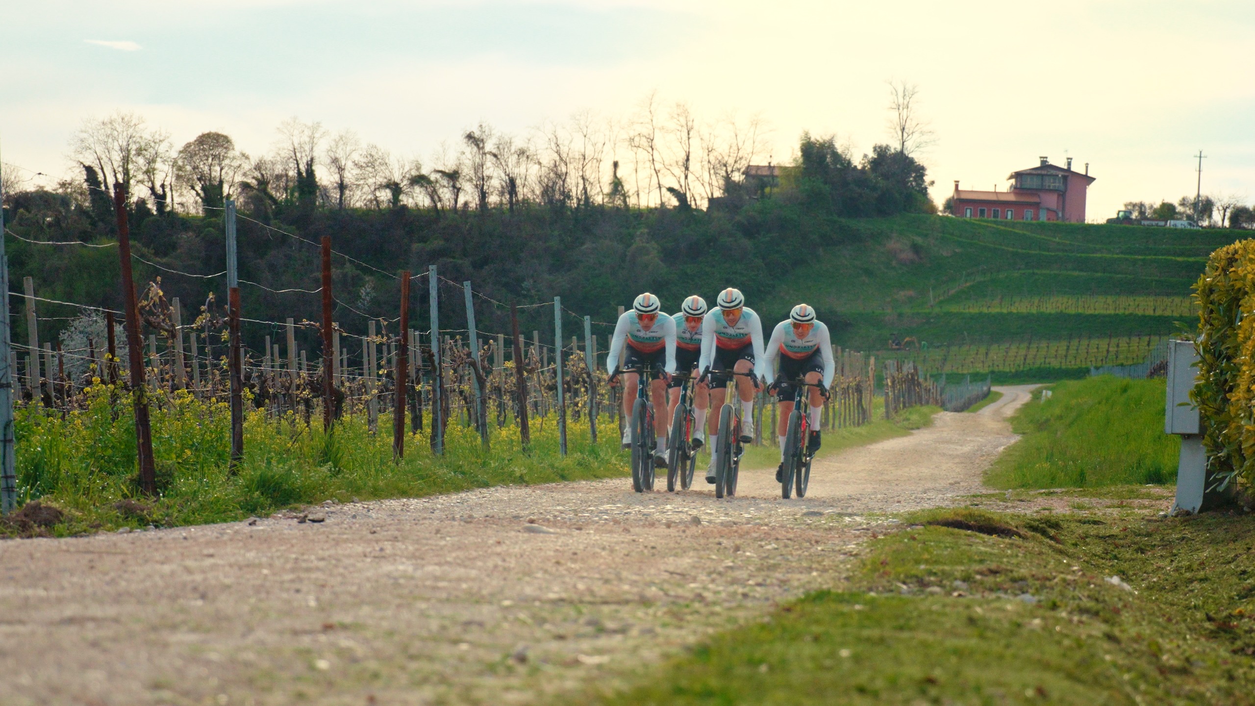 Undrafted Cycling team riding through Tuscan gravel